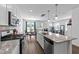 Modern kitchen featuring stainless appliances and beautiful granite countertops flowing into the breakfast and living room at 608 Creekway Dr, Fuquay Varina, NC 27526