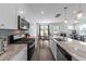 Open-concept kitchen with granite countertops, stainless steel appliances, and views of the dining and living areas at 608 Creekway Dr, Fuquay Varina, NC 27526