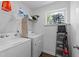 Functional laundry room featuring a washer, dryer, and shelving, providing convenience for laundry tasks at 608 Creekway Dr, Fuquay Varina, NC 27526