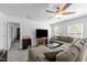 Bright living room with a large sectional sofa, coffee table, and TV, creating a cozy and inviting atmosphere at 608 Creekway Dr, Fuquay Varina, NC 27526