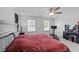 Spacious main bedroom with a bed, exercise bike, and vanity, offering a comfortable and functional space at 608 Creekway Dr, Fuquay Varina, NC 27526