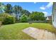 Spacious backyard featuring a stone fire pit, patio, and mature trees offering shade at 611 Edenberry Dr, Durham, NC 27713