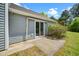 Back patio with sliding glass door, stone patio, and siding, plus backyard landscaping to boost curb appeal at 611 Edenberry Dr, Durham, NC 27713