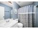 Cozy bathroom features a framed mirror, toilet and shower with a privacy curtain, and neutral color palette at 611 Edenberry Dr, Durham, NC 27713