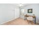 Bright bedroom with modern desk and chair setup; perfect for a home office and features a cozy closet at 611 Edenberry Dr, Durham, NC 27713