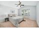 Spacious bedroom with large bay windows offering plenty of natural light, modern ceiling fan, and neutral carpeting at 611 Edenberry Dr, Durham, NC 27713