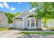 Charming single-story home with light blue siding, well-maintained landscaping, and attached garage at 611 Edenberry Dr, Durham, NC 27713