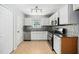 Well-equipped kitchen with white cabinets, stainless steel appliances, and decorative backsplash at 611 Edenberry Dr, Durham, NC 27713