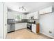 Modern kitchen with white cabinets, stainless steel appliances, and tiled backsplash at 611 Edenberry Dr, Durham, NC 27713