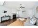 Comfortable living room with a fireplace, ceiling fan, and neutral color palette at 611 Edenberry Dr, Durham, NC 27713