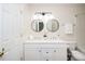 Bathroom featuring double sink vanity, modern light fixtures, and tiled floor at 614 Canyon Lake Cir, Morrisville, NC 27560