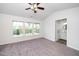Well-lit bedroom with triple windows, ceiling fan, and en-suite bathroom at 614 Canyon Lake Cir, Morrisville, NC 27560