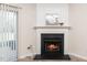 Living room fireplace with white mantel and tile hearth, adjacent to sliding glass doors at 614 Canyon Lake Cir, Morrisville, NC 27560