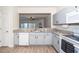 Charming kitchen with a breakfast bar, granite countertops, and gray cabinets, ideal for casual dining at 614 Canyon Lake Cir, Morrisville, NC 27560