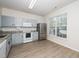 Updated kitchen featuring gray cabinets, granite countertops, and stainless steel appliances, blending style with function at 614 Canyon Lake Cir, Morrisville, NC 27560