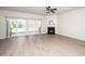 Spacious living room with hardwood floors, a cozy fireplace, and natural light, ideal for relaxing or entertaining at 614 Canyon Lake Cir, Morrisville, NC 27560