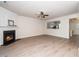 Open-concept living room featuring a fireplace, wood floors, and a view into the kitchen at 614 Canyon Lake Cir, Morrisville, NC 27560