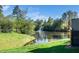 Scenic pond with a fountain surrounded by lush greenery and mature trees at 614 Canyon Lake Cir, Morrisville, NC 27560