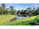 Scenic pond with a fountain surrounded by lush greenery and mature trees at 614 Canyon Lake Cir, Morrisville, NC 27560