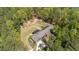 Birds eye view of a home nestled within trees, showcasing solar panels, and large backyard at 626 Bailey Rd, Coats, NC 27521