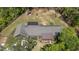 Wide aerial image shows solar panels, backyard playground and fenced area on the property at 626 Bailey Rd, Coats, NC 27521