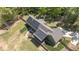 Expansive aerial view showcasing home, solar panels, driveway, and beautifully landscaped yard at 626 Bailey Rd, Coats, NC 27521