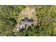 Scenic aerial shot of wooded property, highlighting a home surrounded by trees and a long driveway at 626 Bailey Rd, Coats, NC 27521