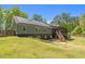View of the house featuring solar panels, a screened-in porch and a spacious yard at 626 Bailey Rd, Coats, NC 27521