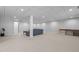 Spacious basement featuring a large sectional sofa and ample open floor space at 626 Bailey Rd, Coats, NC 27521
