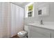 Bright bathroom with white fixtures, shower with curtain, and modern vanity at 626 Bailey Rd, Coats, NC 27521