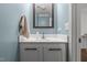 Bathroom featuring a vanity with a sleek mirror and modern fixtures, complemented by blue walls at 626 Bailey Rd, Coats, NC 27521