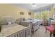 Spacious bedroom with three beds, offering comfort and style in a sunny setting at 626 Bailey Rd, Coats, NC 27521