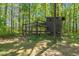 Outdoor chicken coop with fenced enclosure located in a wooded area at 626 Bailey Rd, Coats, NC 27521