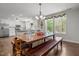 Dining room with a large wooden table and bench seating, complemented by a charming chandelier at 626 Bailey Rd, Coats, NC 27521