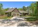 A charming home with a 2-car garage, set amongst lush greenery, with long driveway at 626 Bailey Rd, Coats, NC 27521