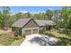 Charming two-story house featuring a two-car garage, lush lawn, and mature trees at 626 Bailey Rd, Coats, NC 27521