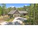 Beautiful exterior featuring lush landscaping, two-car garage, and a large driveway at 626 Bailey Rd, Coats, NC 27521