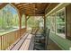 Inviting front porch featuring a porch swing and rocking chairs at 626 Bailey Rd, Coats, NC 27521