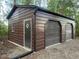 Metal garage featuring roll-up doors, side door, and a window, offering secure storage at 626 Bailey Rd, Coats, NC 27521