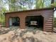 Two-bay garage with parking for multiple vehicles and outdoor equipment at 626 Bailey Rd, Coats, NC 27521