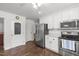 Bright kitchen featuring white cabinets, stainless steel appliances, and hardwood floors at 626 Bailey Rd, Coats, NC 27521