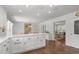 Spacious kitchen with white cabinets, and hardwood floors, that seamlessly flows to other rooms at 626 Bailey Rd, Coats, NC 27521