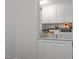 Functional laundry room equipped with modern washer and dryer units and ample storage at 626 Bailey Rd, Coats, NC 27521