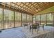 Inviting screened porch with wicker furniture set for relaxing and enjoying the outdoors at 626 Bailey Rd, Coats, NC 27521