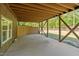 View of under the porch, featuring a covered concrete slab and view of backyard at 626 Bailey Rd, Coats, NC 27521