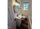 Bathroom featuring vanity, dark fixtures, an updated mirror, toilet, and a tub at 710 Dothan Ave, Burlington, NC 27217