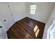 Bedroom featuring hardwood floors, white walls, baseboards, and a sunlit window at 710 Dothan Ave, Burlington, NC 27217