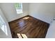 Bedroom featuring hardwood floors, white walls, baseboards, and a sunlit window at 710 Dothan Ave, Burlington, NC 27217