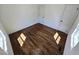 A bedroom with hardwood floors, and two white doors accenting the room at 710 Dothan Ave, Burlington, NC 27217