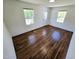 Well-lit bedroom with hardwood floors and neutral walls, featuring multiple windows for ample daylight at 710 Dothan Ave, Burlington, NC 27217